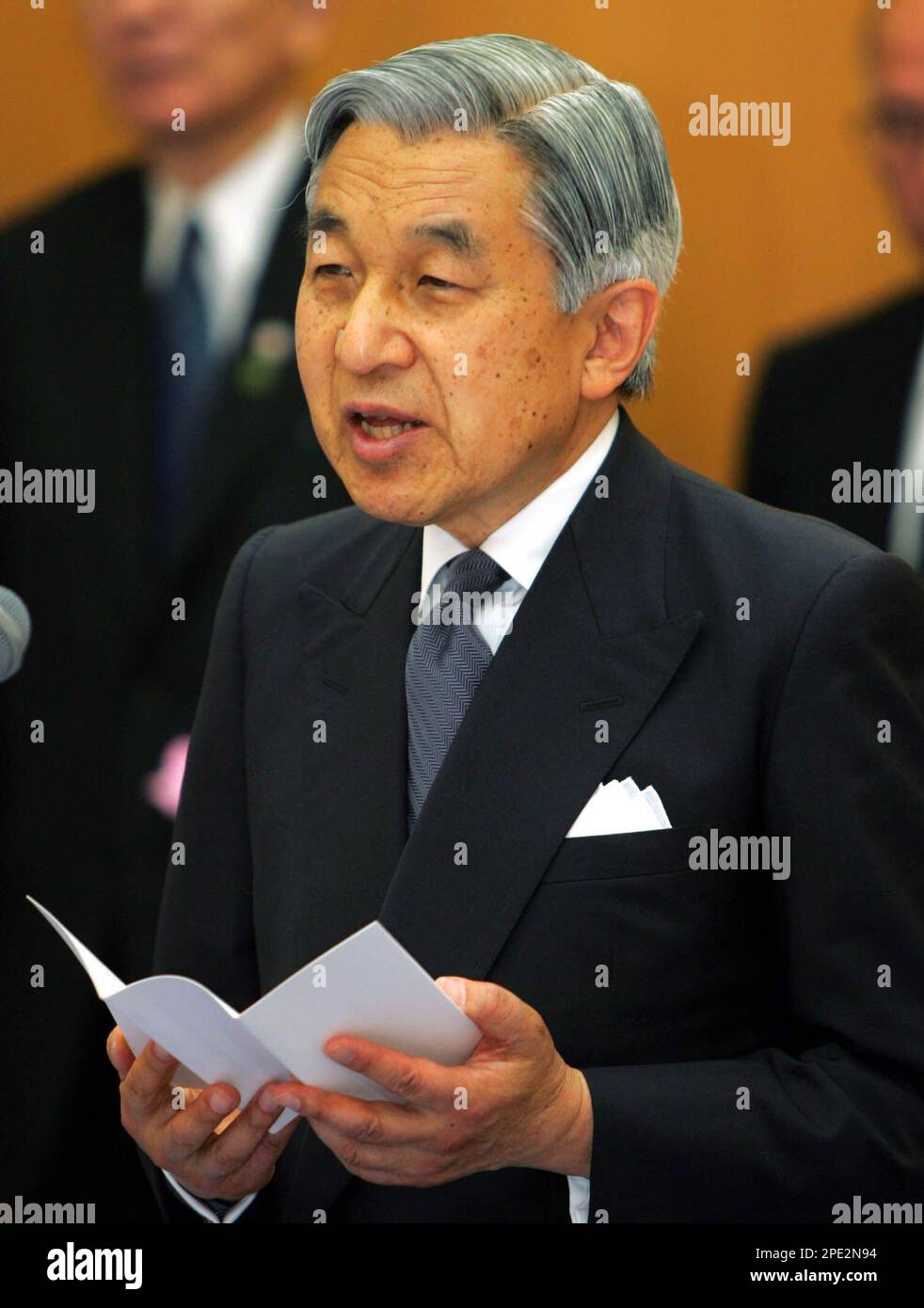 Japan's Emperor Akihito delivers a speech to officials as he boards a special plane with Empress