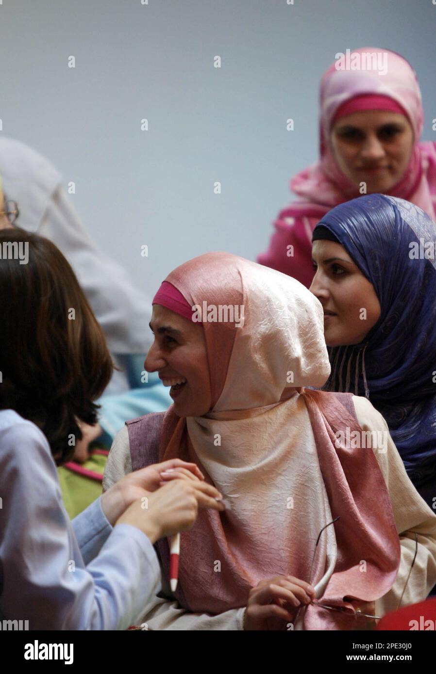 Kosovo Albanian women chat during a fashion show for Islamic female clothing, Thursday June 23, 2005, in Pristina