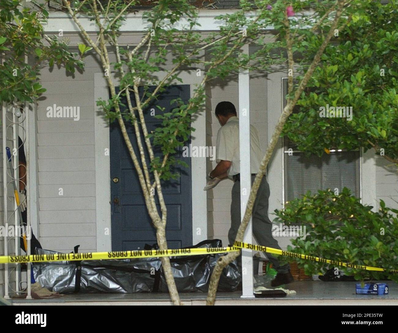 An investigator from the Alexandria coroner's office prepares to