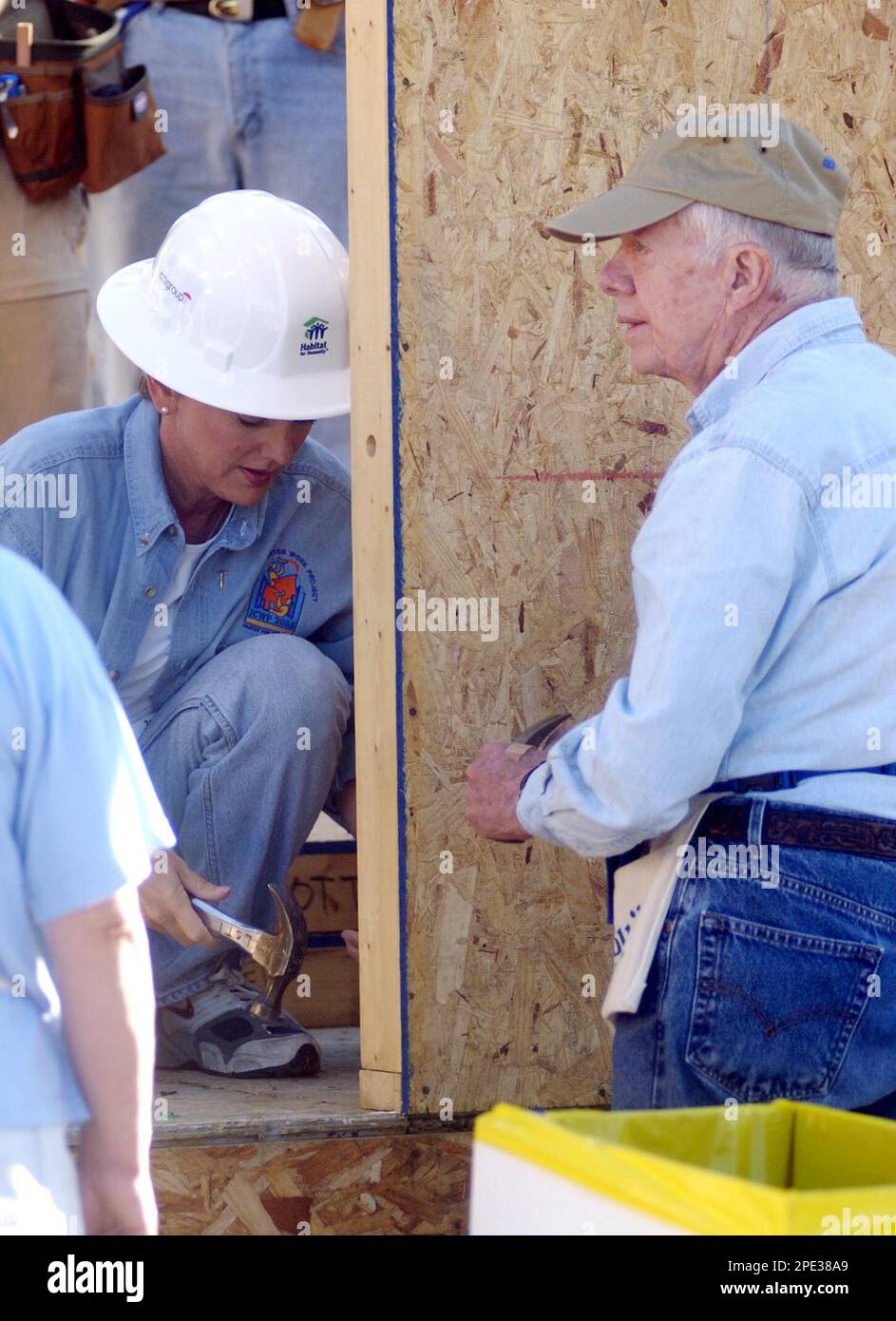 Michigan Gov. Jennifer Granholm, left, helps former President Jimmy