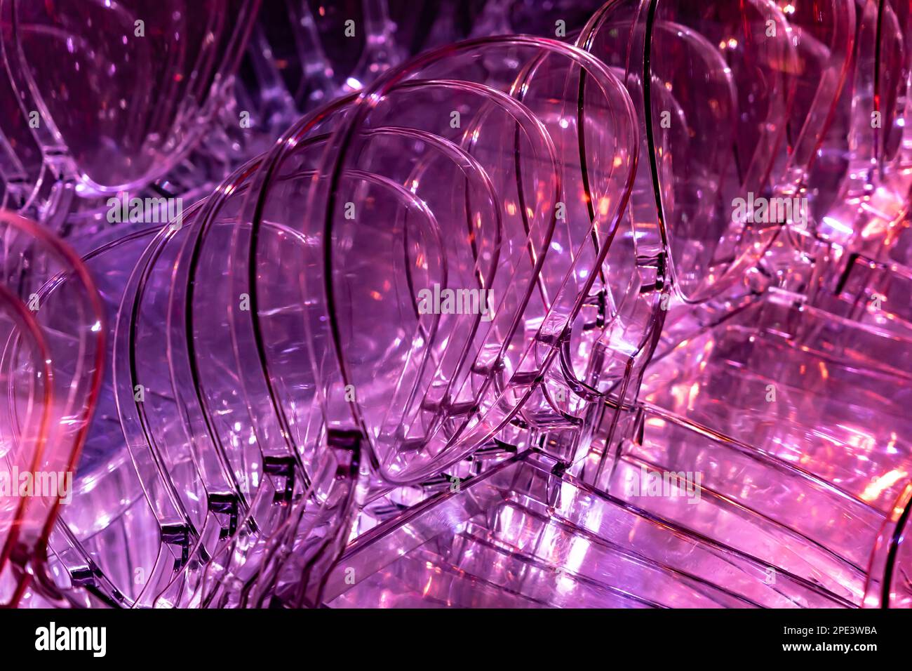 Illuminated Purple Plastic Chairs Stacked in Switzerland Stock Photo