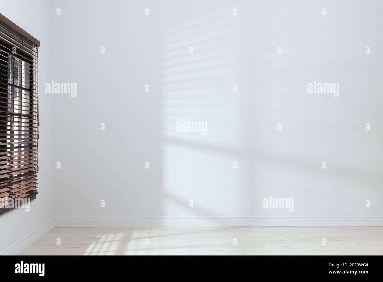 Empty room with white walls, large window and wooden floor Stock Photo