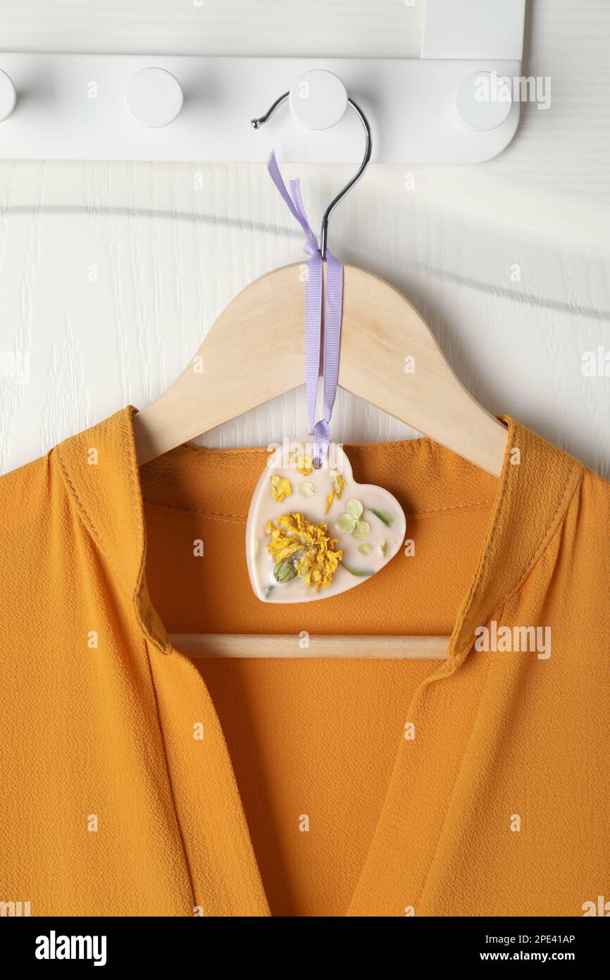 Scented sachet with flowers and stylish clothes on hanger Stock Photo