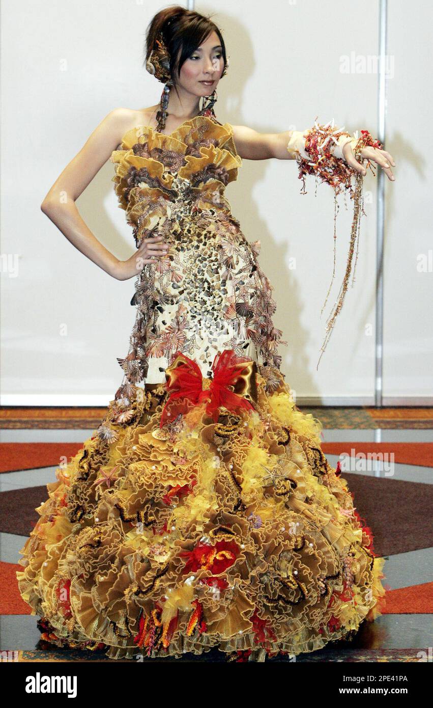 A Thai model poses on catwalk, wearing attire designed by Anujit Maulprom  during the fashion contest for Thailand wedding designer award in Bangkok  on Friday June 10, 2005. Ten contestants joined the