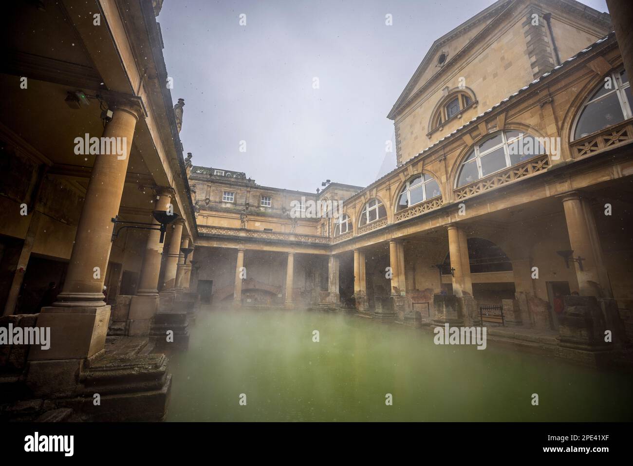 Snow falling on the Great Bath at the Roman Baths in Bath, Somerset Stock Photo