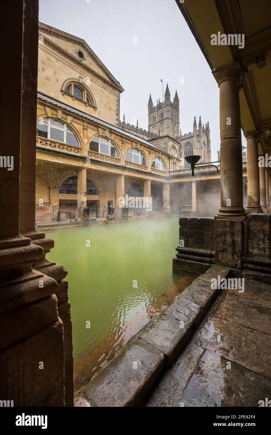 Snow falling on the Great Bath at the Roman Baths in Bath, Somerset Stock Photo