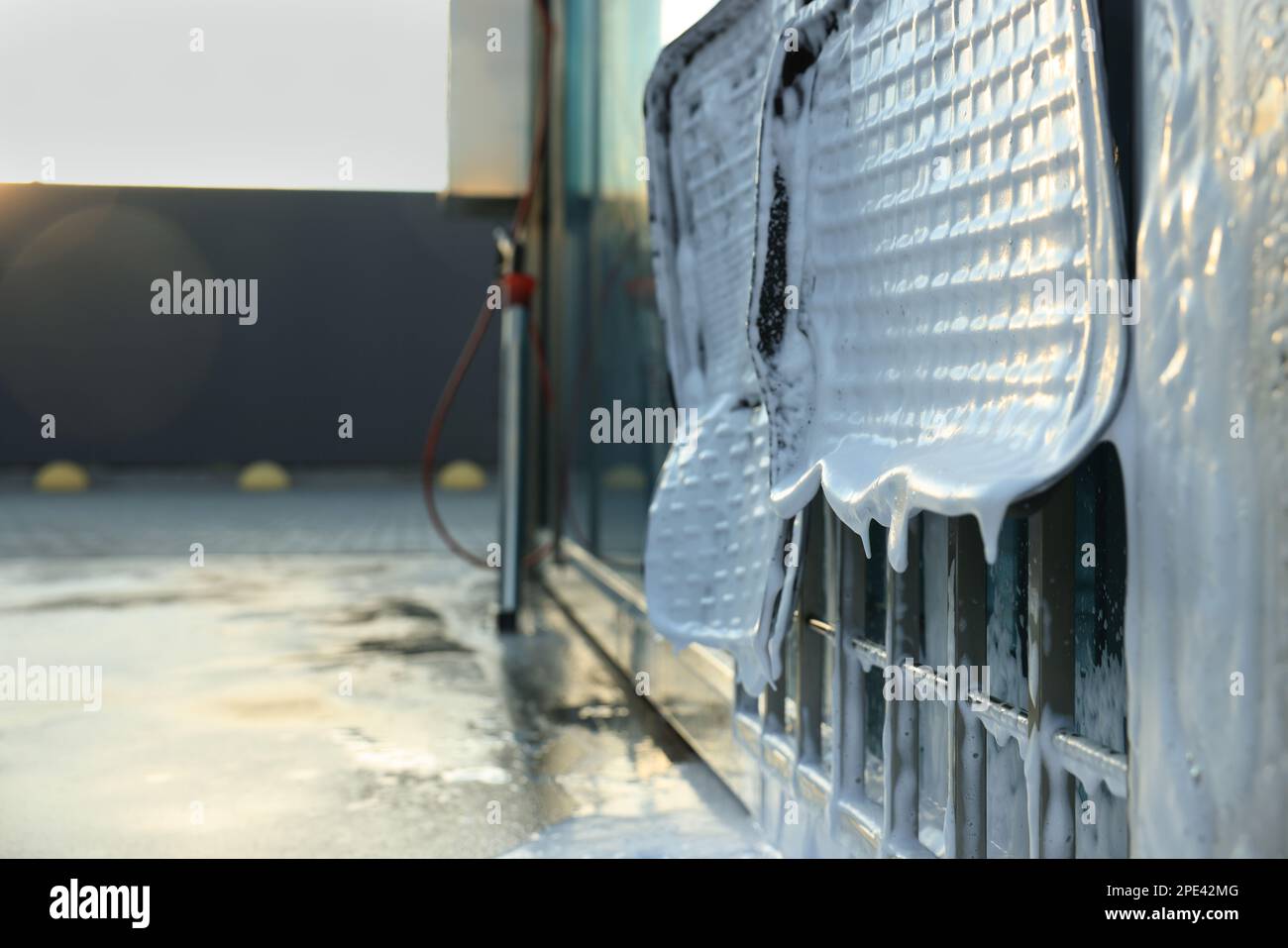 Auto mats covered with foam hanging at car wash Stock Photo Alamy