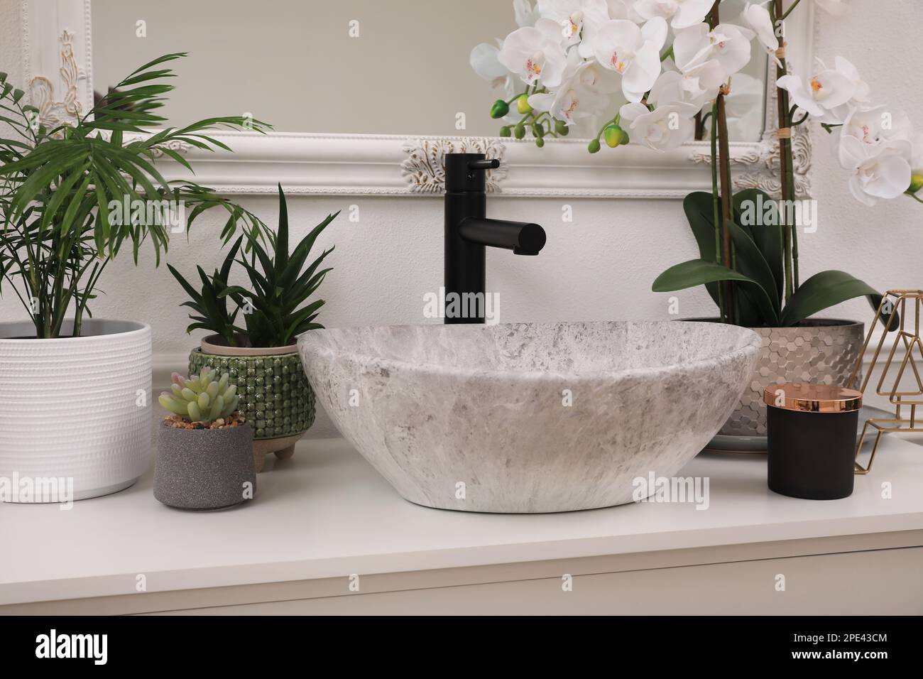 Stylish sink and beautiful houseplants in bathroom. Interior design Stock Photo