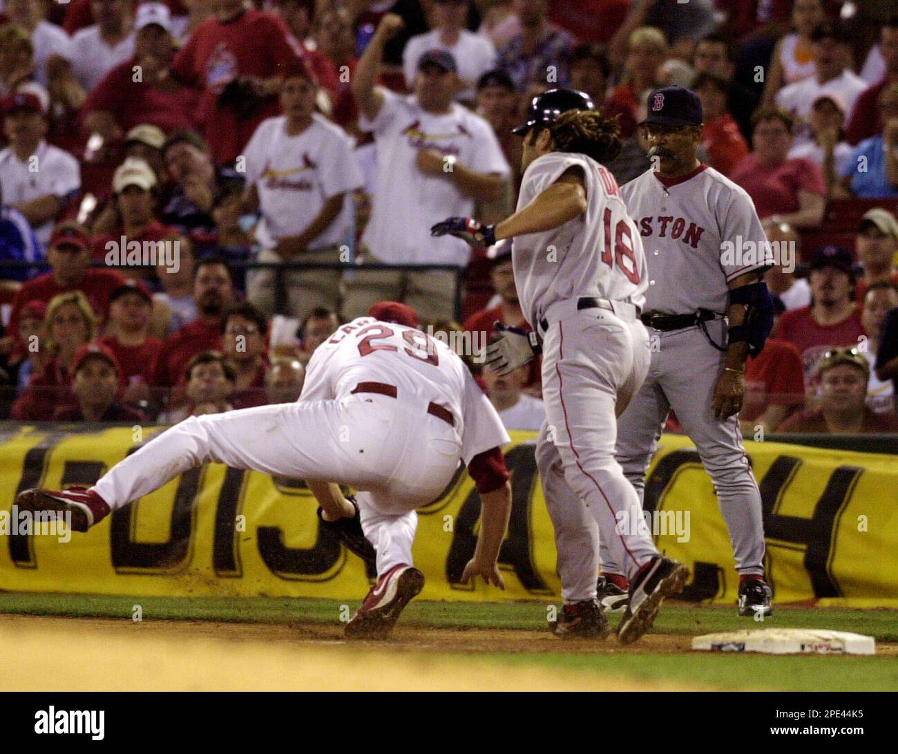 St. Louis Cardinals' Chris Carpenter (29) tumbles to the ground after  colliding with Boston Red Sox's Johnny Damon and beating Damon to the bag  for the out in the sixth inningin St.