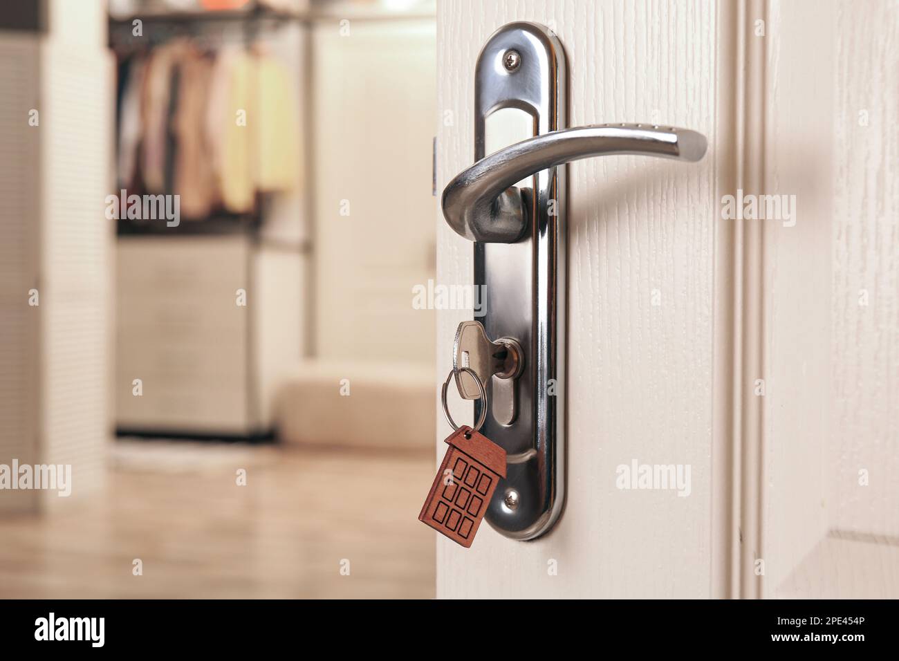 Closeup view of open door with key in room Stock Photo Alamy