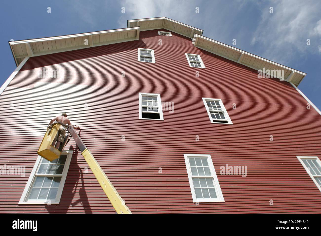 Chris Davis of Colchester, Vt., adds a second coat to the side of an