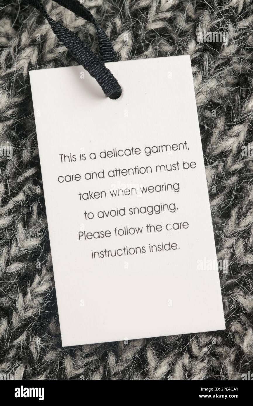 Close up of luxury clothing hang tag Delicate garment swing tag Close up of luxury clothing hang tag Delicate garment swing tag