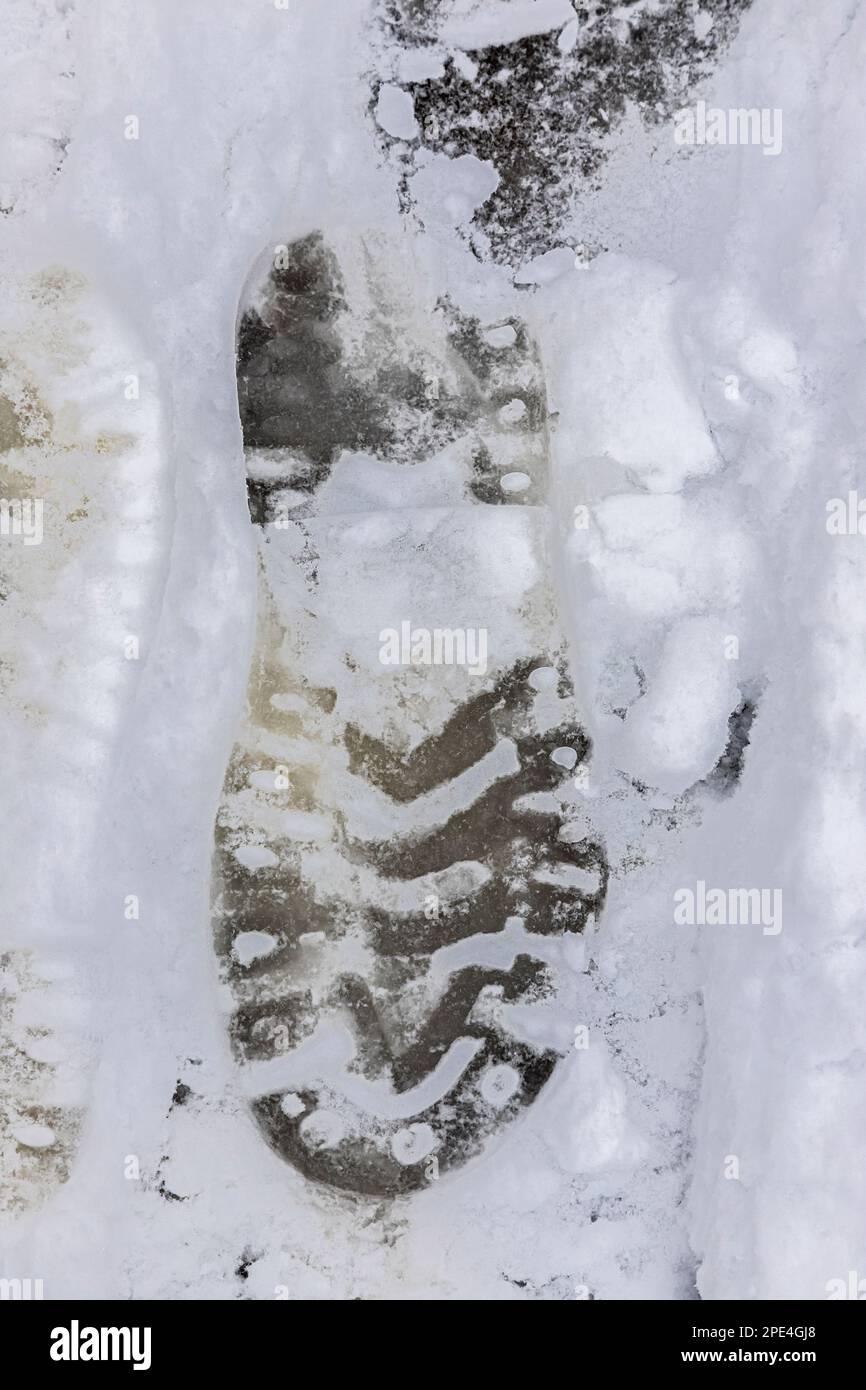 Top view of the footprint of shoes boots on fresh snow. The winter season. Stock Photo