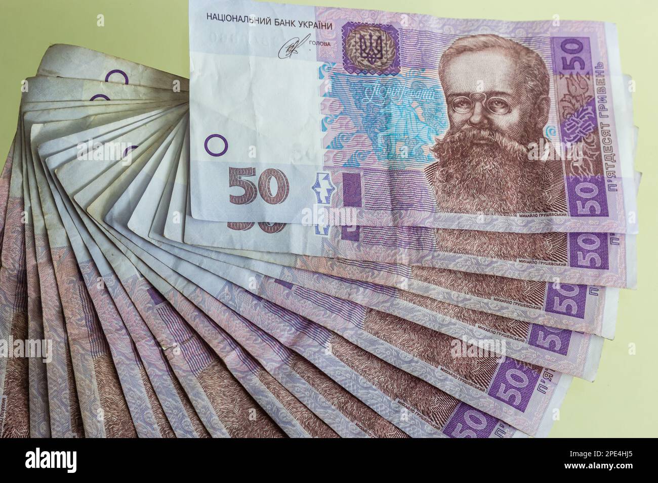 Ukrainian paper money is laid out on a blue background. 50 hryvnia banknotes. Stock Photo