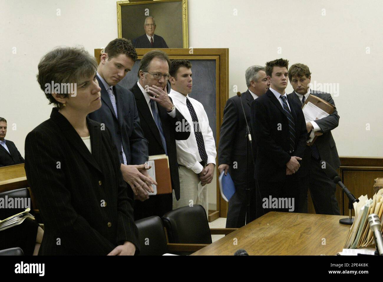 Norfolk County Assistant District Attorney Jean Marie Carroll, left, talks  with Judge Mark S. Coven during the arraignment of former Milton Academy  students Pasko Skarica, second from left; Jay Driscoll, white shirt,