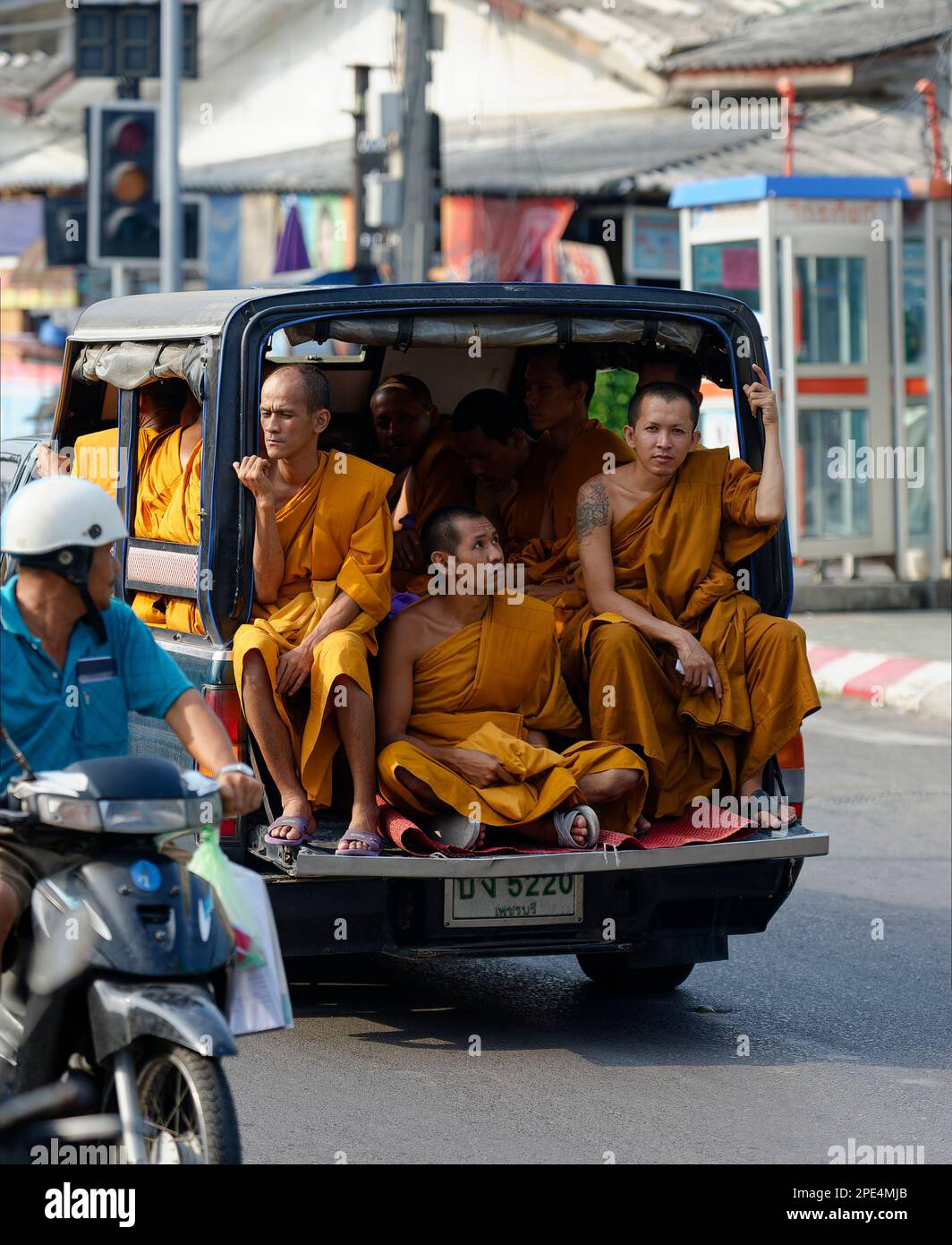 Buddhist monks in back of a truck in Thailand Stock Photo