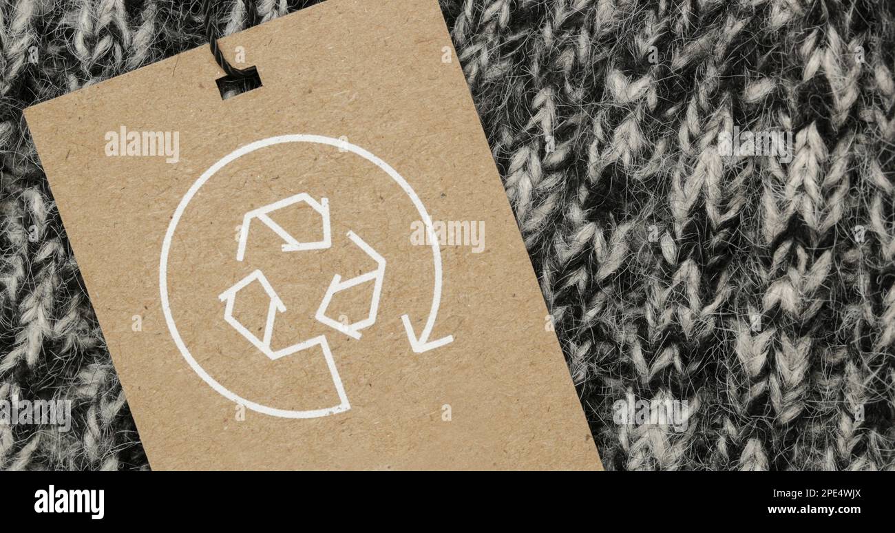 Close up of clothing tag with recycle icon. Recycling products concept. Zero waste, suistainale production, environment care and reuse concept. Stock Photo