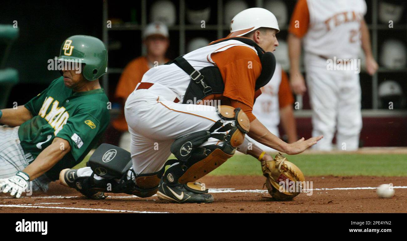Baylor's Michael Griffin, left, scores as Texas catcher Clay