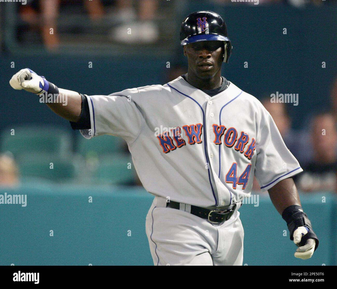 New York Mets' Mike Cameron raises his hand after scoring on a double by Cliff  Floyd against Florida Marlins' Brian Moehler in the fourth inning Friday,  May 27, 2005 in Miami. (AP