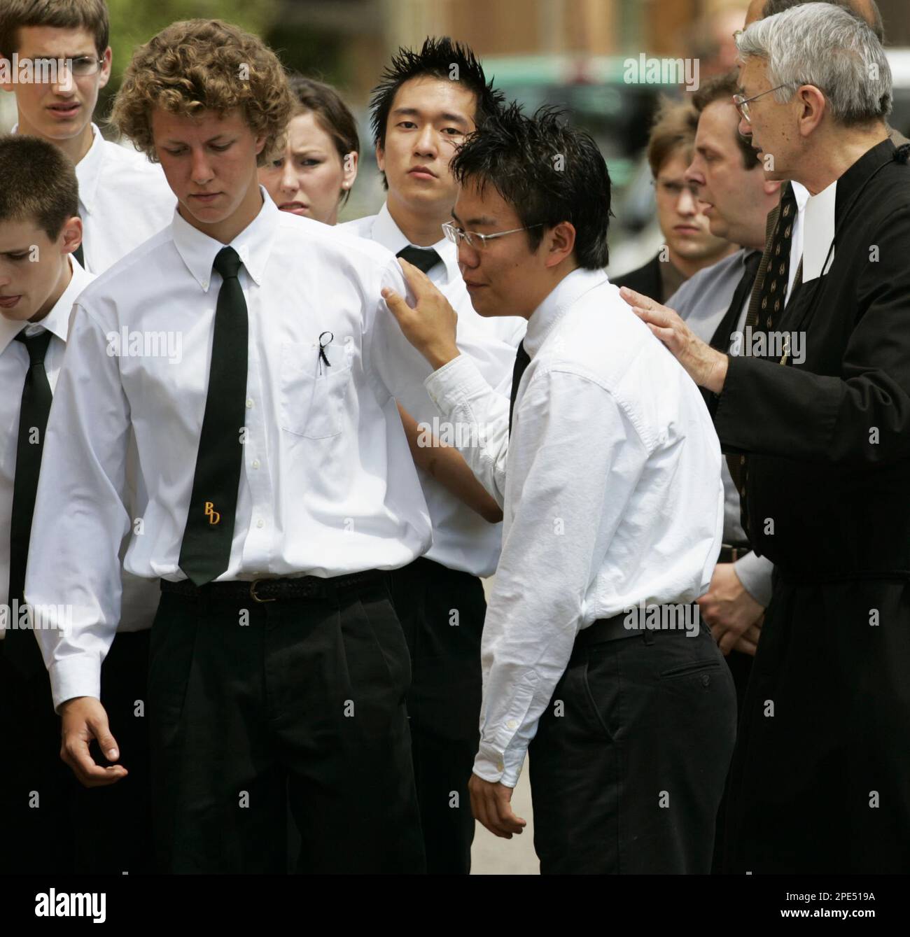 Brother Rene D. Roy, right, consoles unidentified classmates of JoBeth