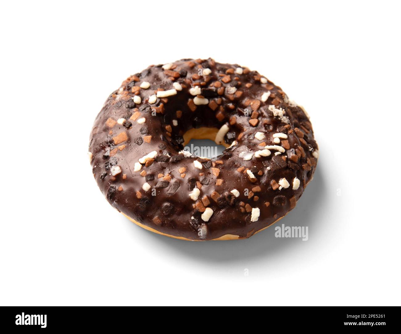 One donut in chocolate glaze sprinkled with pieces of white, milk and