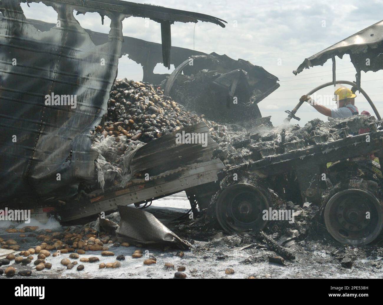 Cleo Springs, Okla. fire marshal Guy Robinson dowses smoldering raw