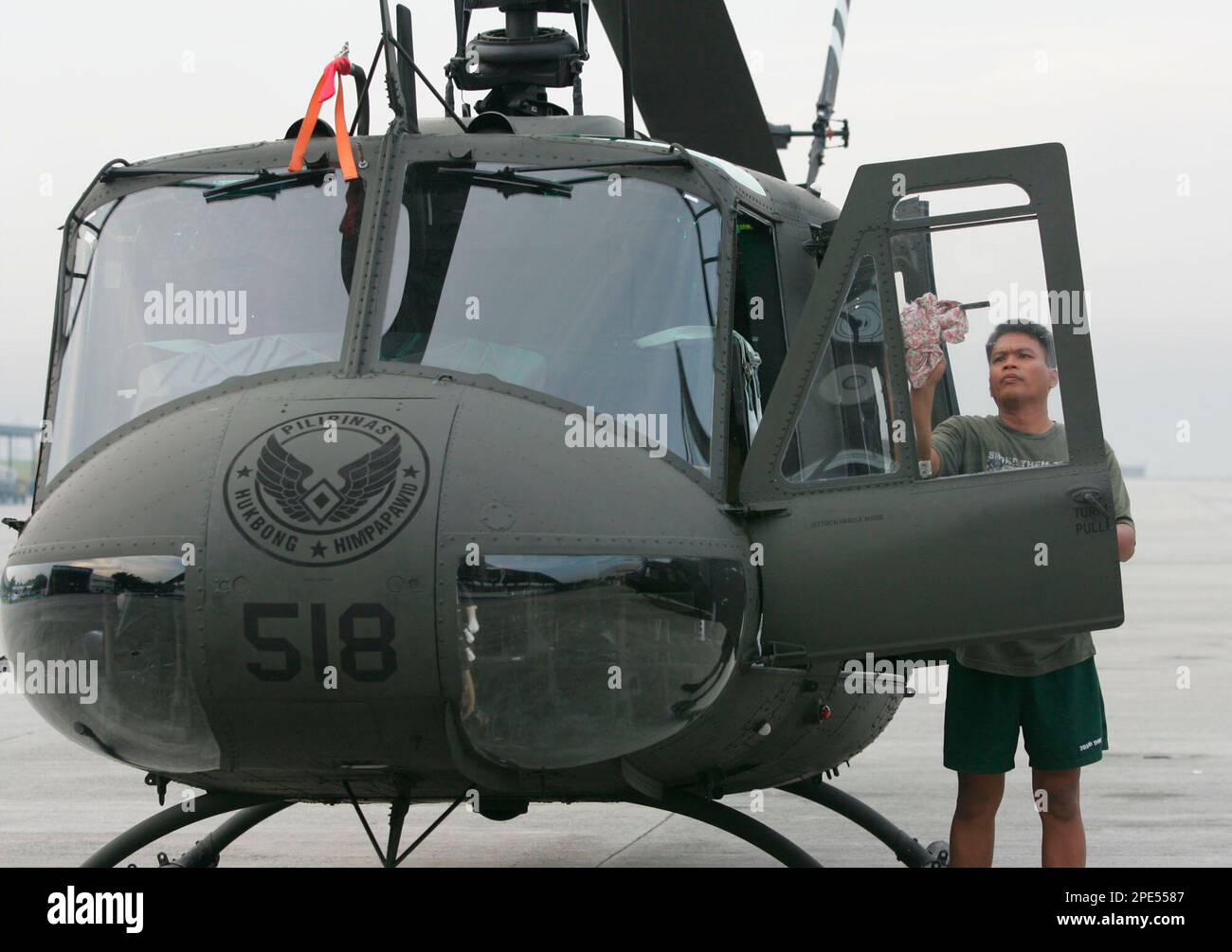 A Philippine Air Force crewman cleans one of three newlyrefurbished UH