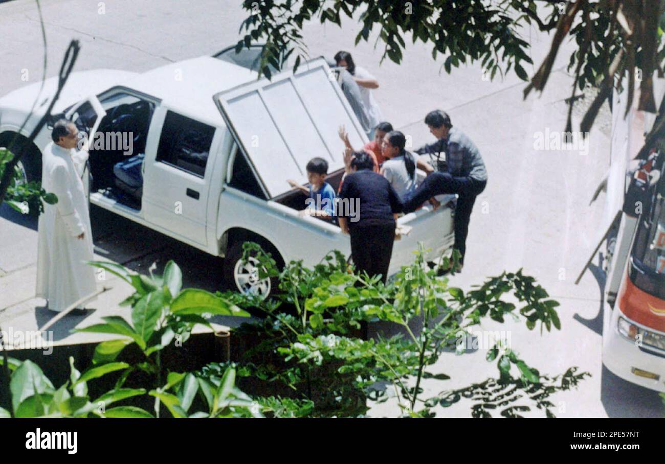Catholic bishop Emmanuel Cabajar, left, looks at hostages who boarded ...