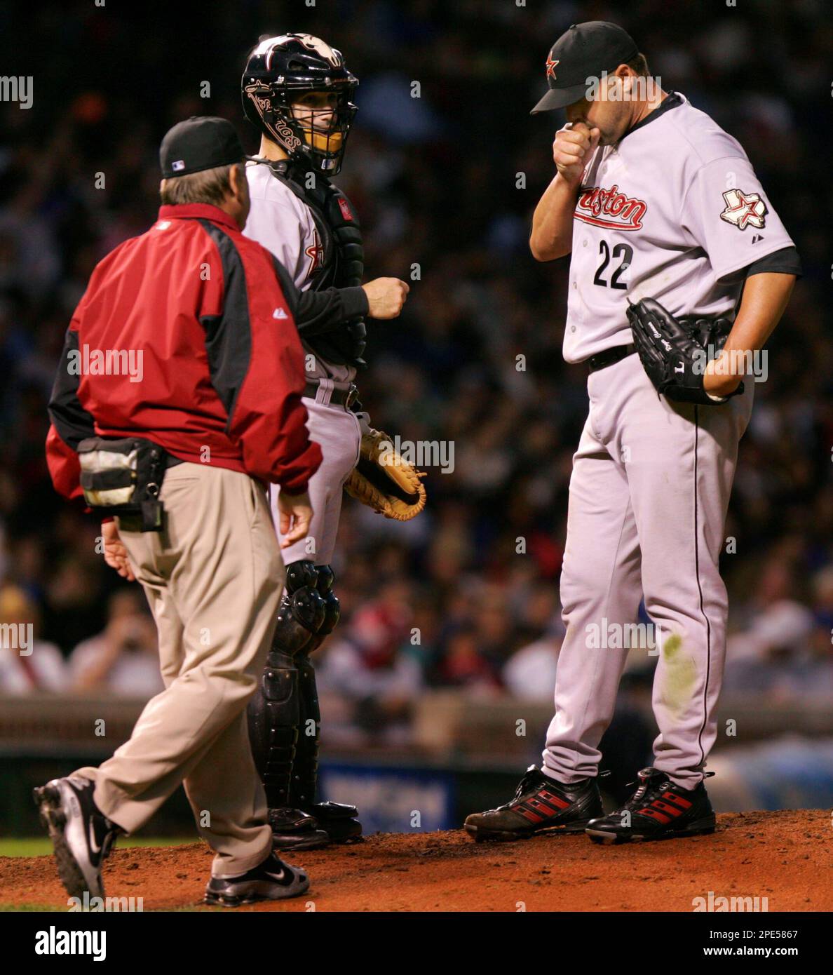 Houston Astros starting pitcher Roger Clemens, right, is visited on the  mound by Astros trainer Dave Labossiere, right, and catcher Brad Ausmus,  center, during the fifth inning against the Chicago Cubs Tuesday