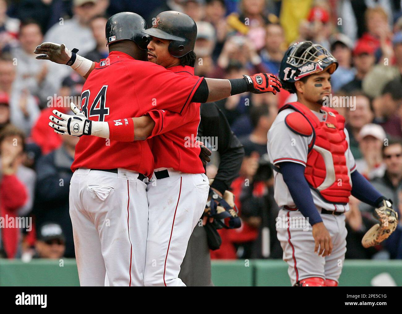 Boston Red Sox's Manny Ramirez hugs teammate David Ortiz (34