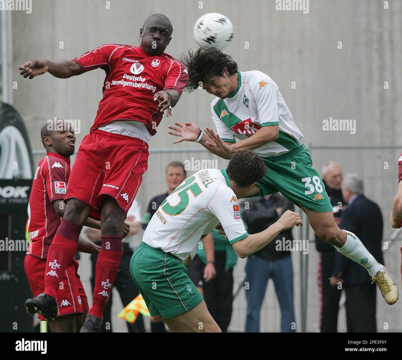 Kaiserslauterns soccer player Lucien Mettomo, left, fights for the ball  against Valerien Ismael,front, and Nelson Antonio Valdez of Werder Bremen  during their first division soccer match, Saturday May 21, 2005, in the