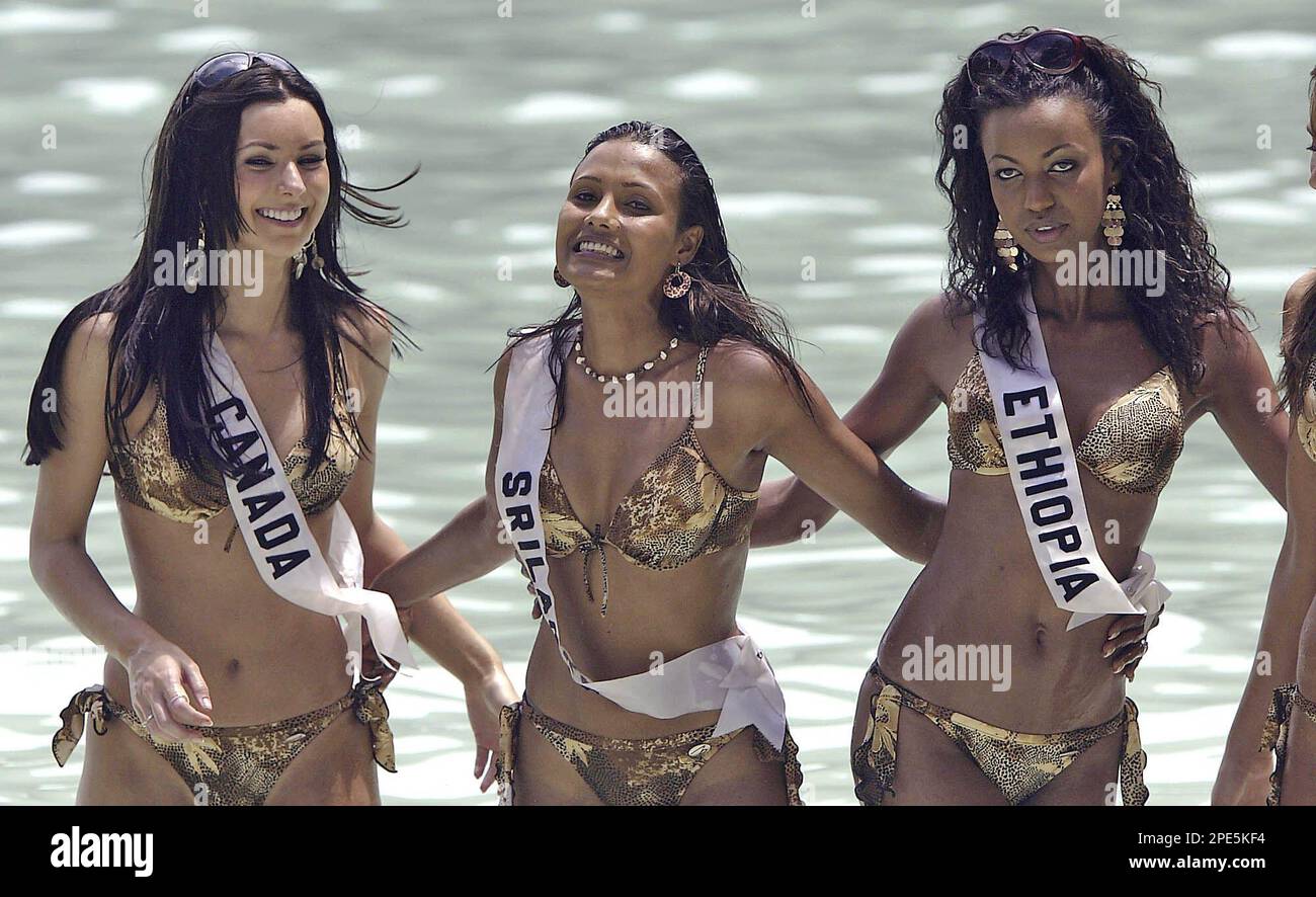 Natalie Glebova, Miss Canada Universe 2005, left, Rozanne Diasz, Miss Sri Lanka Universe 2005, and Atetegeb Tetsaye, Miss Ethiopia Universe 2005, right, pose for photographs Thursday, May 19, 2005, on Phi Phi ley island off the coast from Phuket, Thailand. All are contestants in the upcoming Miss Universe competition. (AP Photo/David Longstreath) Stock Photo