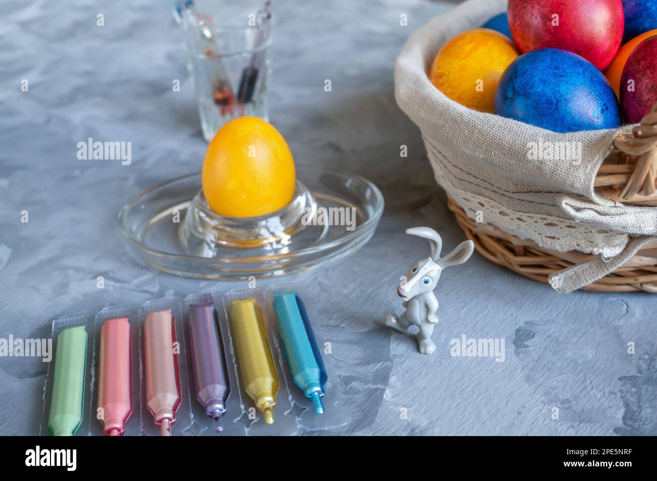 process of coloring eggs for the Easter holiday using ampoules with dye ...