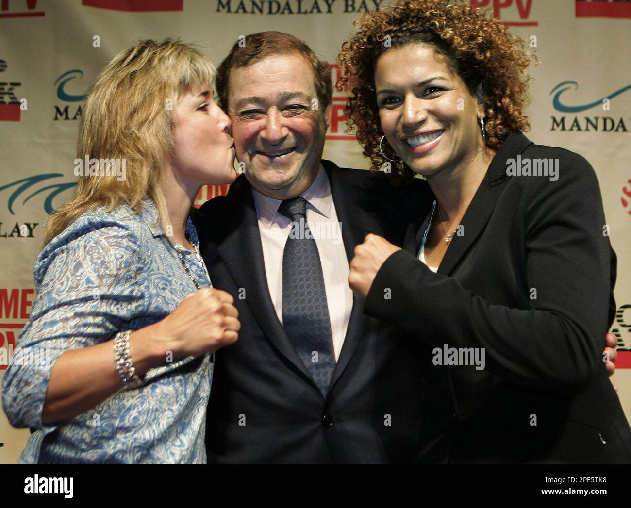 Christy Martin, left, kisses Top Rank CEO Bob Arum as she and Lucia ...