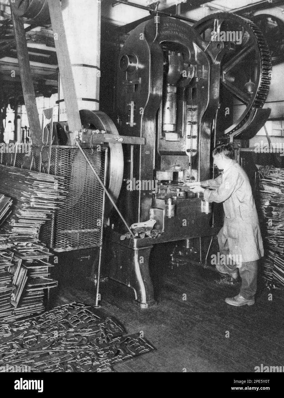 A power press at the Birmingham Small Arms Company Limited factory, c1933. The power press can be seen making motorcycle engine parts for BSA Motorcycles. Stock Photo
