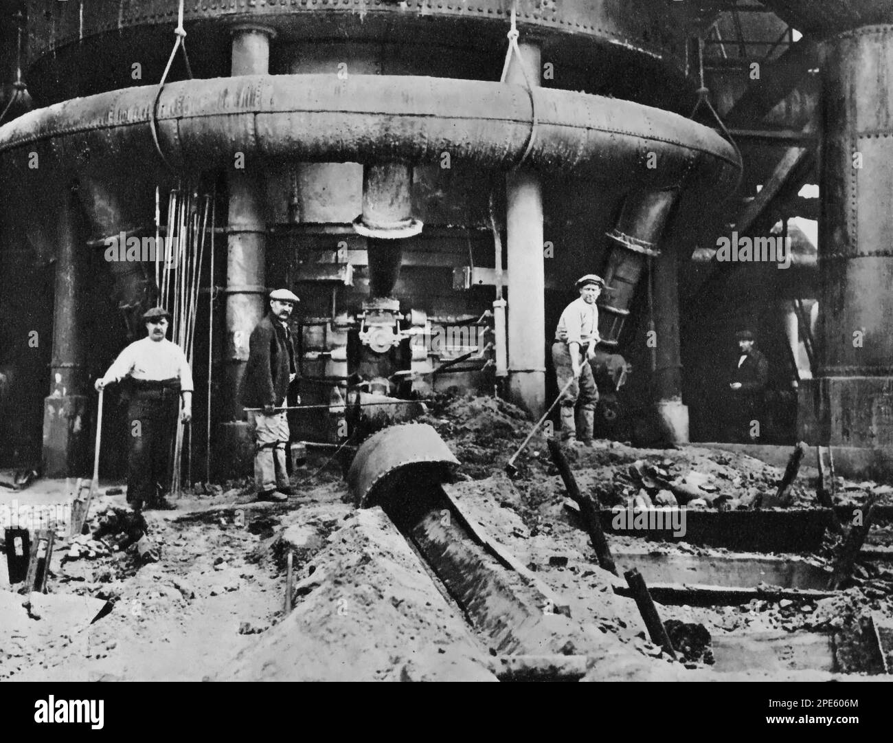 The bottom of a blast furnace, c1933. A blast furnace is a type of metallurgical furnace used for smelting to produce industrial metals, generally pig iron, but also others such as lead or copper. Blast refers to the combustion of air being supplied above atmospheric pressure. Stock Photo