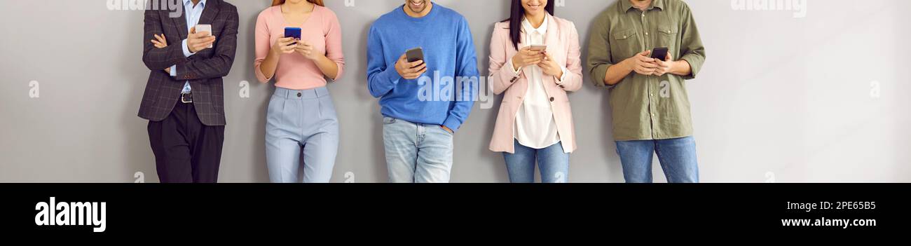 Group of happy young people using smartphones for text messaging or watching videos Stock Photo