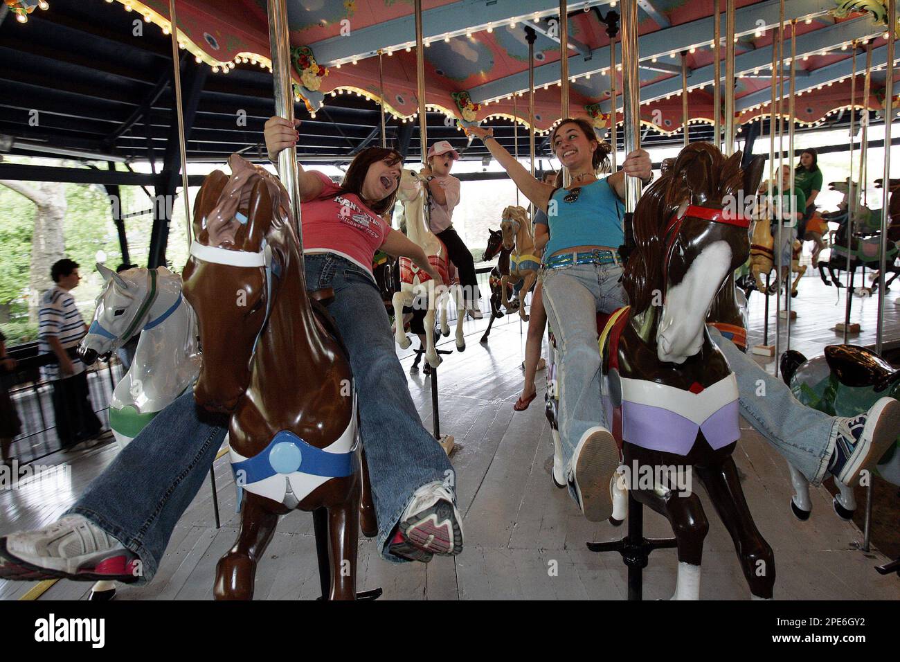 Keystone Oaks High School students Sarah Svidron, left, and friend Amanda Tylka take one of the first rides on the newly rebuilt 1926 wooden carousel at Kennywood Park in West Mifflin, Pa., image