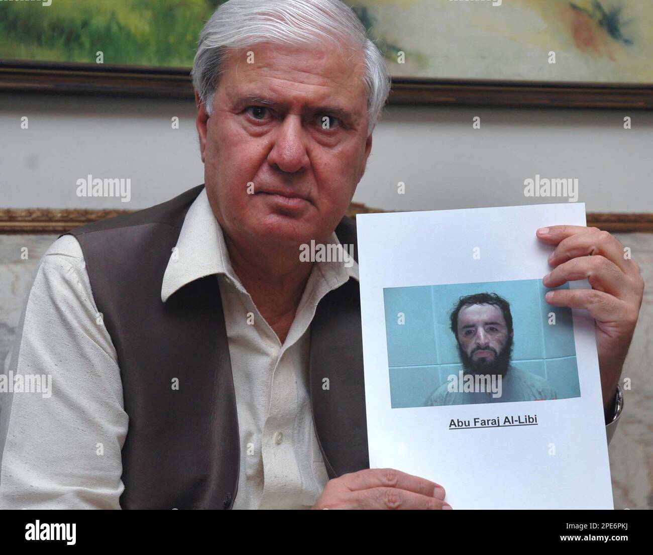 Pakistans Interior Ministry Aftab Khan Sherpao shows a picture of senior al-Qaida suspect Abu Faraj al-Libbi after his arrest, during a press conference in Islamabad, Pakistan on Wednesday, May 4, 2005. Libbi, wanted in two attempts to assassinate President Gen. Pervez Musharraf, has been arrested in Pakistan, after a fierce gunbattle, the government said Wednesday, May 4, 2005. (AP Photo/Anjum Naveed) Stock Photo