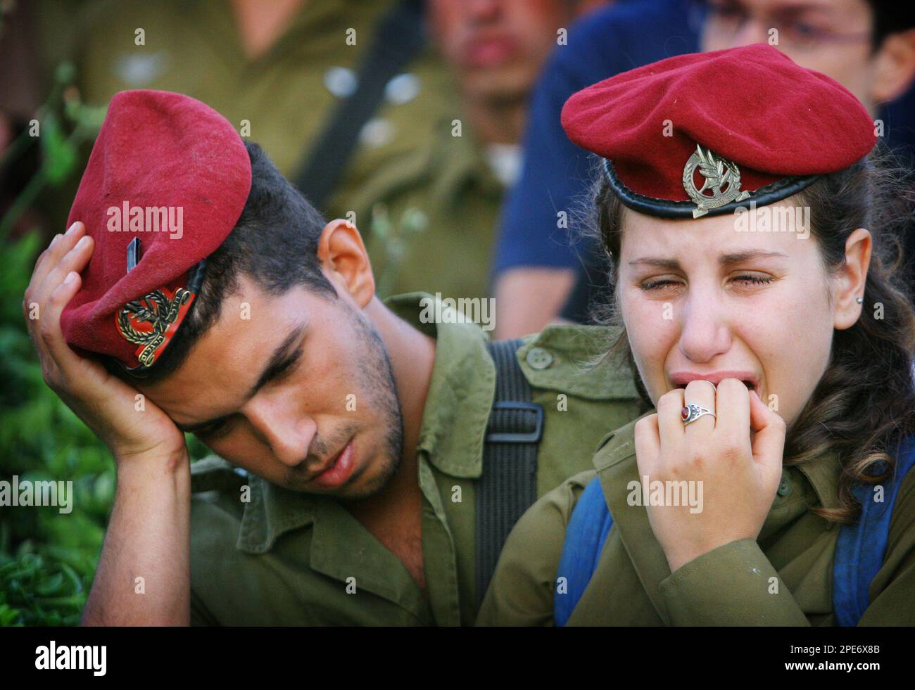Israeli soldiers cry during the funeral of their 21-year-old comrade Dan Talasnikov at the cemetery of the southern Israeli town of Nir Galim Monday May 2, 2005. Talasnikovwas killed when Israeli troops raided the Palestinian West Bank village of Seideh near Tulkarem before dawn Monday and imposed a curfew. A shootout erupted, leaving a militant and the soldier dead.(AP Photo/Ariel Schalit) Stock Photo