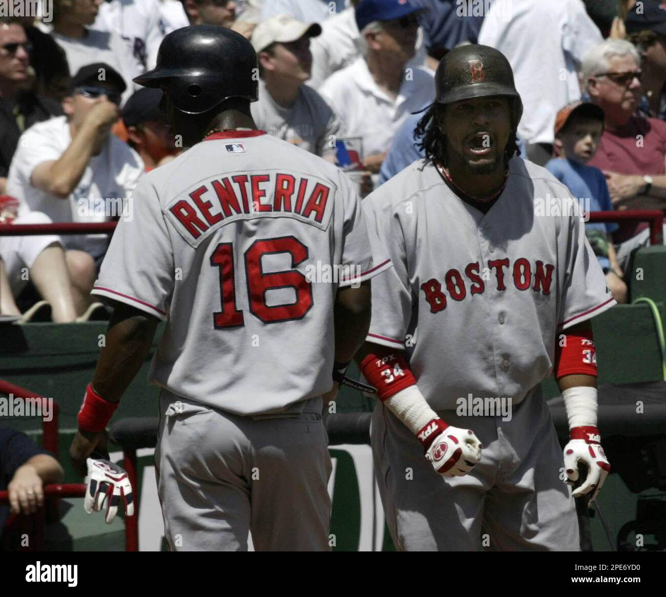 Boston Red Sox' Edgar Renteria, left, is greeted by teammate Manny