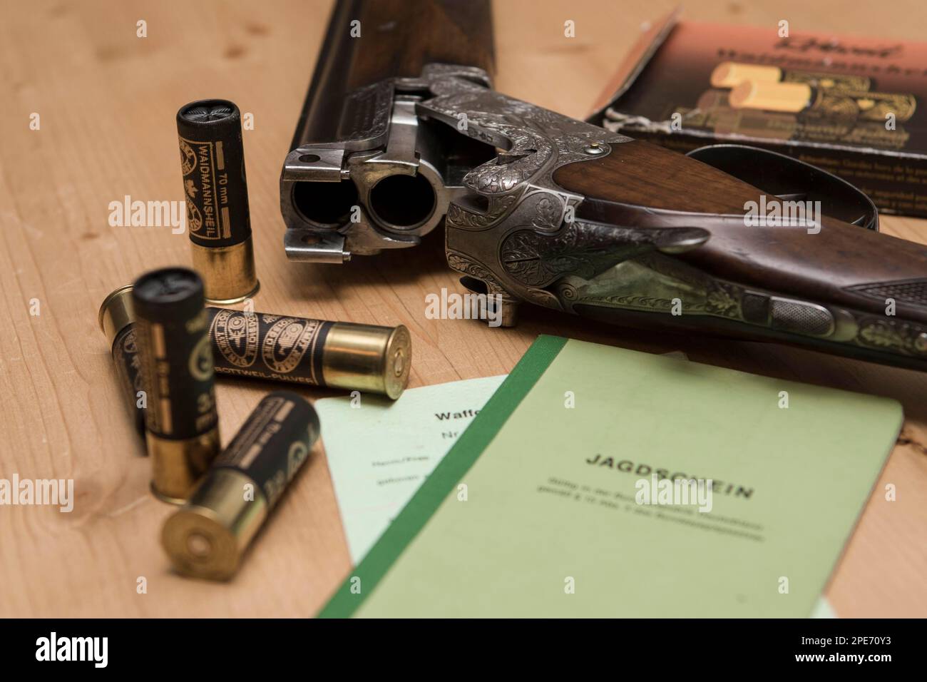 Decorated hunting weapons with ammunition, hunting license and gun