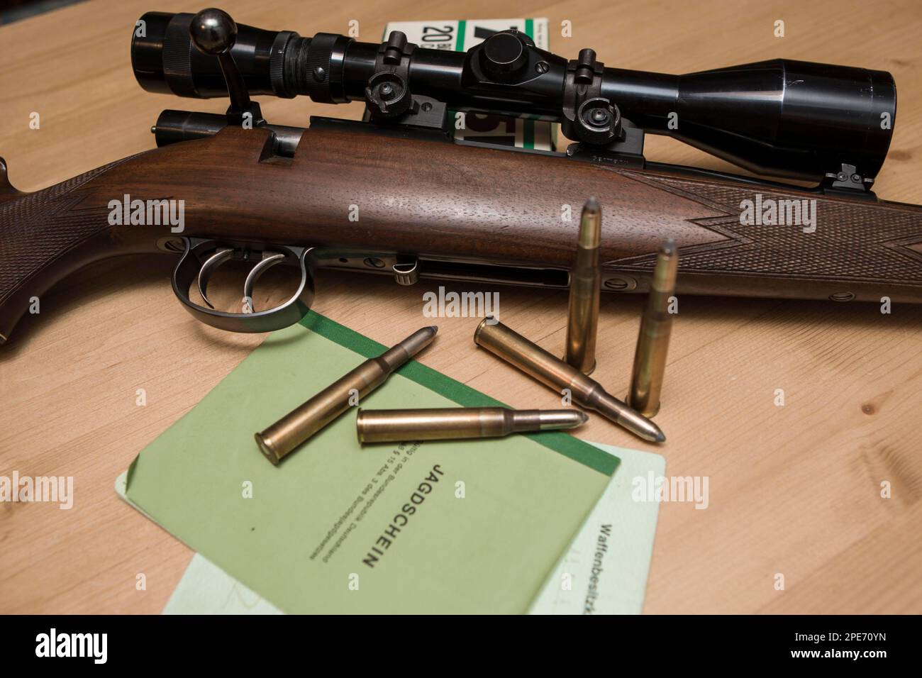 Decorated hunting weapons with ammunition, hunting license and gun