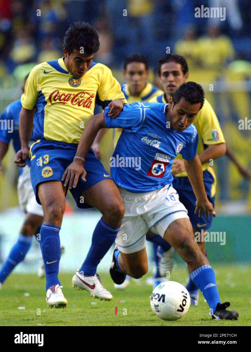 Cruz Azul's soccer player Miguel Zepeda, right, fights for the