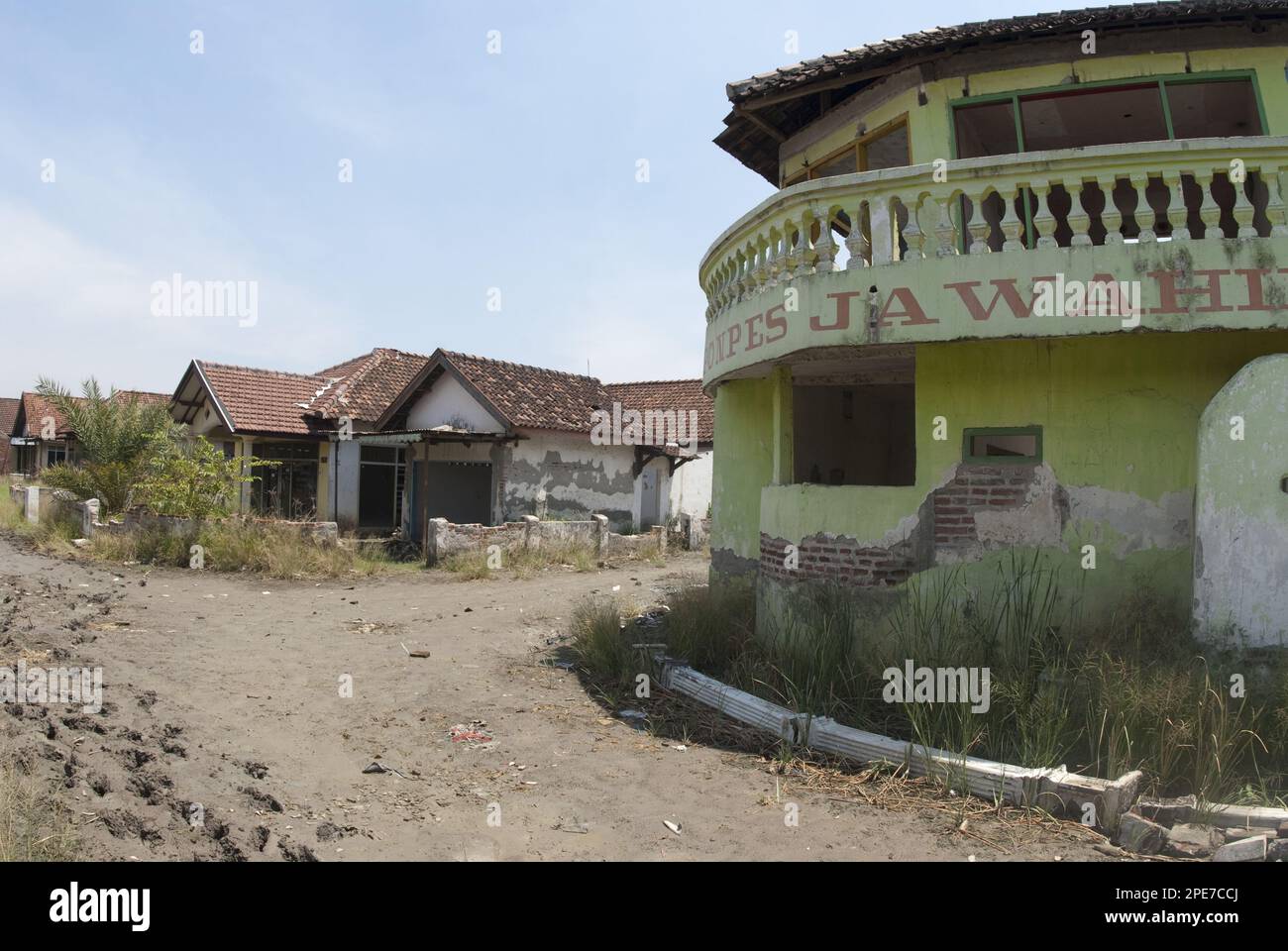 Abandoned village in dried mud after mud volcano flooded by mud lake
