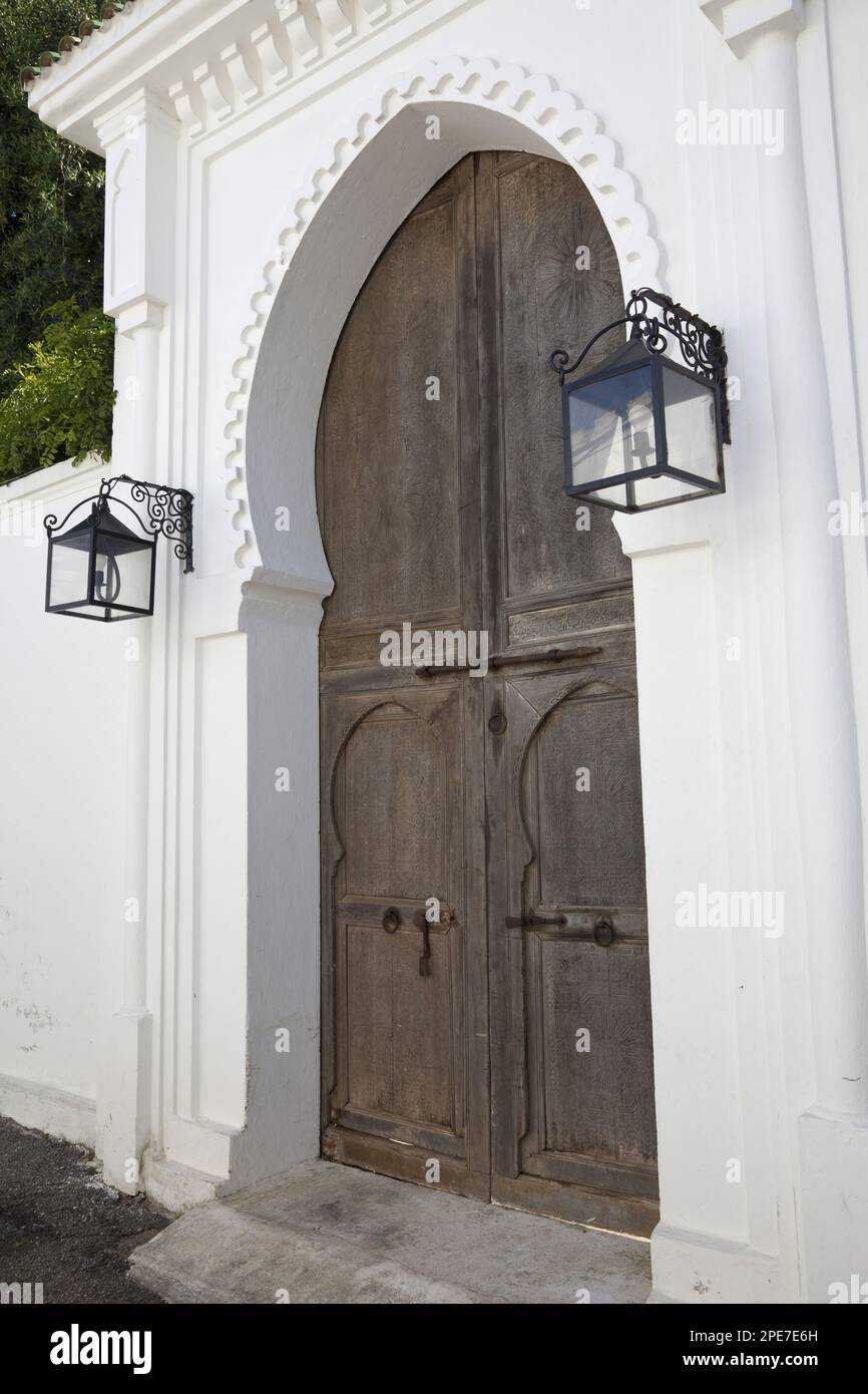 Wooden door and lanterns in a coastal city street, Tangier, Morocco Stock Photo
