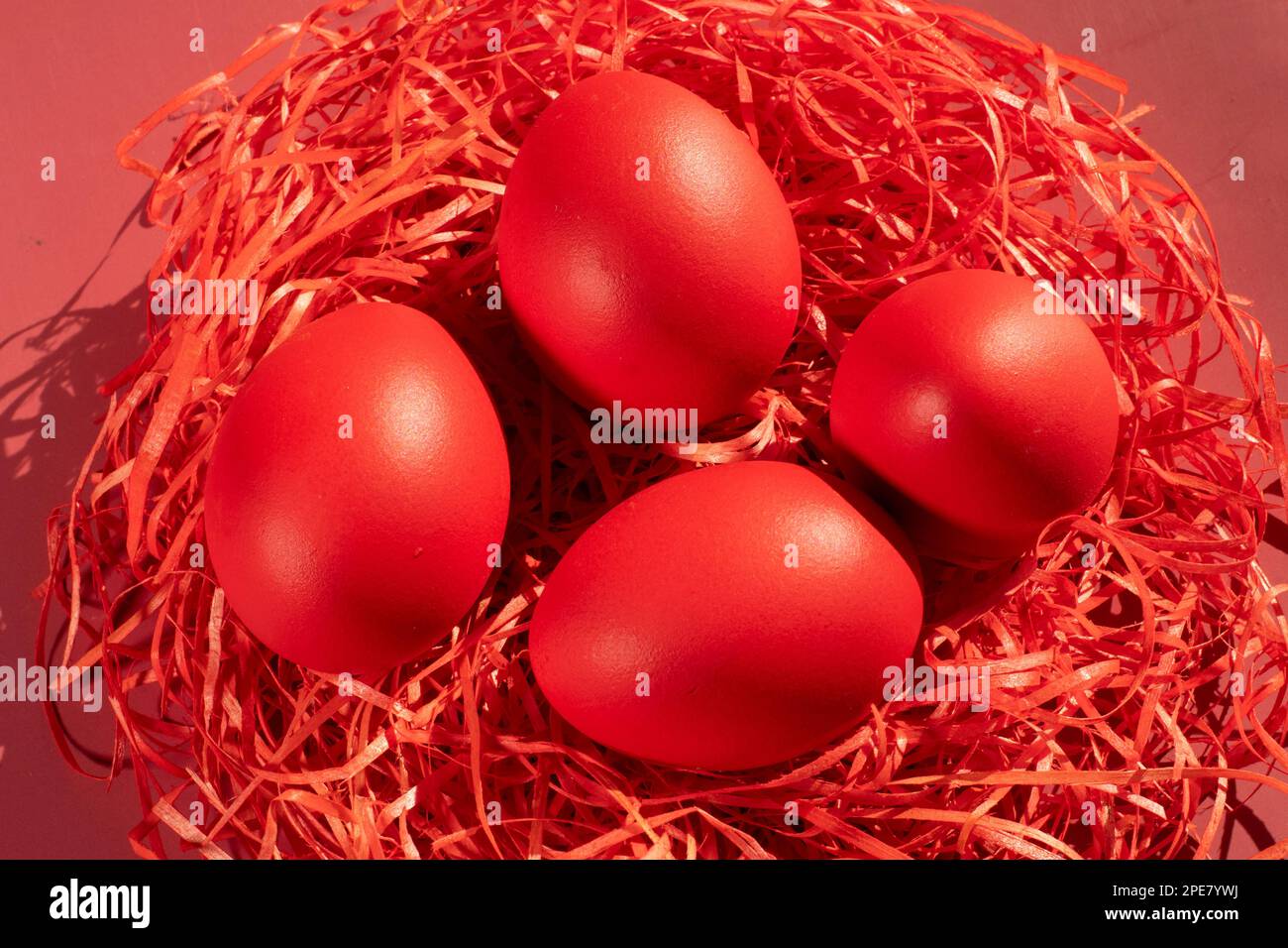 Colored eggs symbolize Easter in shades of red on straw Stock Photo Alamy