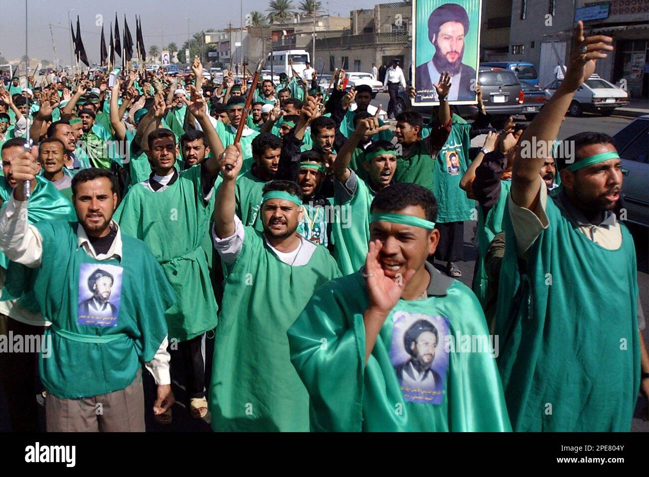 Shiite Iraqis protest against the U.S. military presence in Iraq during a demonstration in Baghdad, Iraq Monday, April 18, 2005. They carry and bear photos of Shiite Ayatollah Mahmoud al-Hassani, who called for the protest.(AP Photo/Mohammed Uraibi) Stock Photo