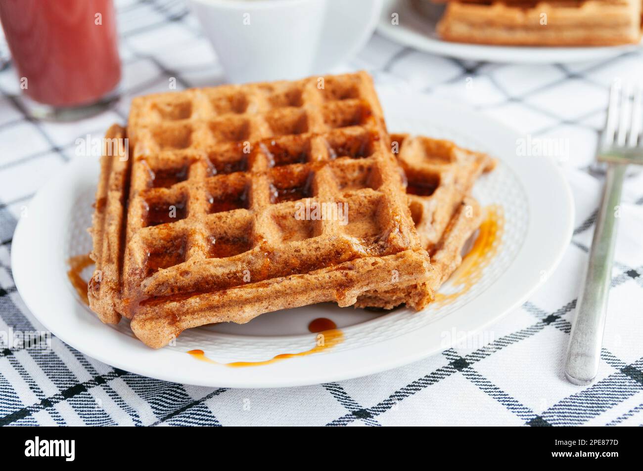 Carrot waffles for breakfast with maple syrup and coffee Stock Photo