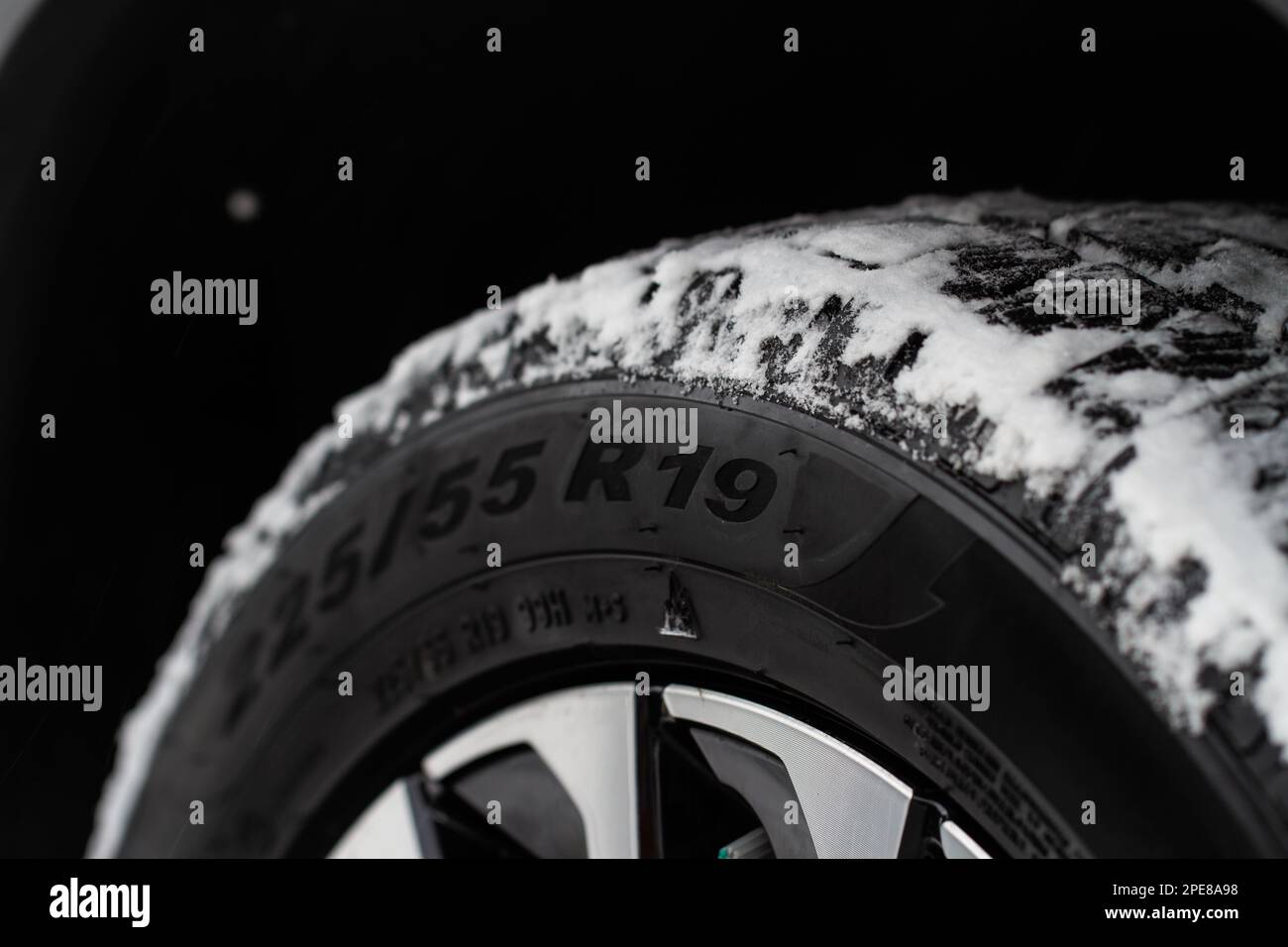 Close up view of snowy tire with tire width, height and wheel diameter